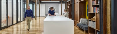 a man and woman standing at a large table in an office